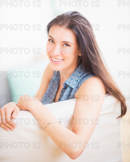Portrait of woman relaxing on sofa