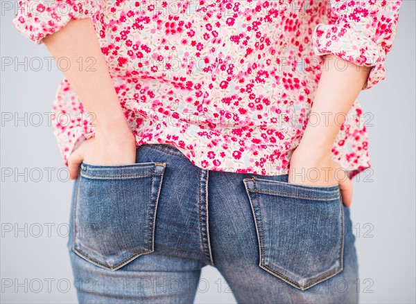 Rear view of woman with hands in pocket