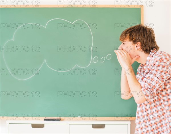 Teenage boy (14-15) having fun in classroom