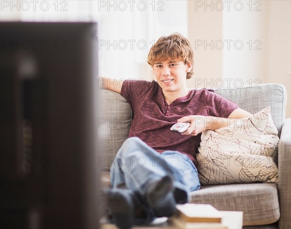 Teenage boy (14-15) watching tv