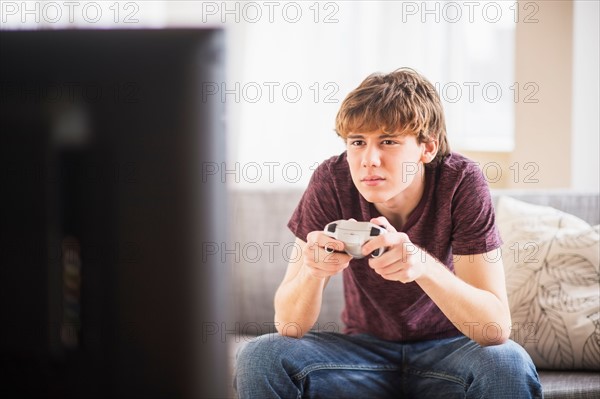 Teenage boy (14-15) playing video game