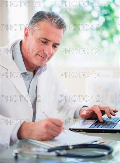 Portrait of doctor working in his office