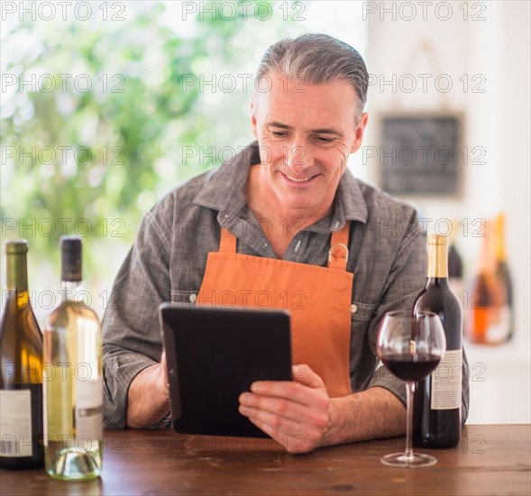 Portrait of restaurant owner using digital tablet