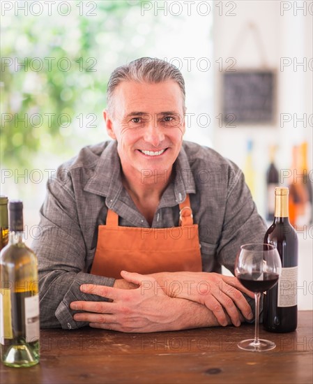 Portrait of cheerful wine store owner