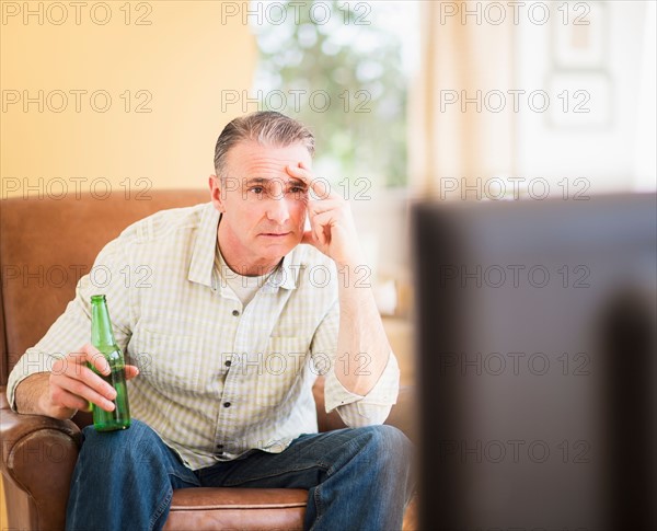 Portrait of man watching tv