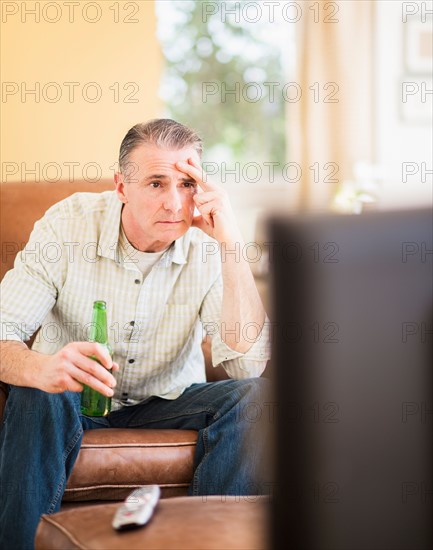 Portrait of man watching tv