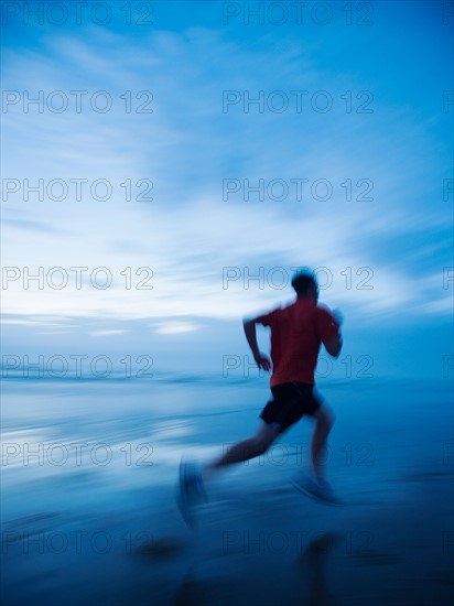 Man running along beach