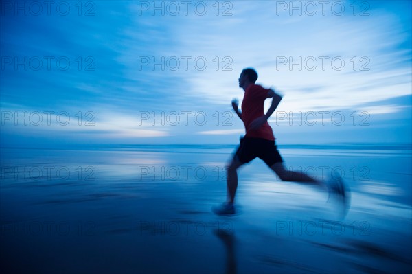 Man running along beach