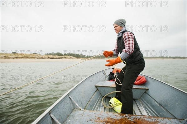 Man pulling net full of crabs