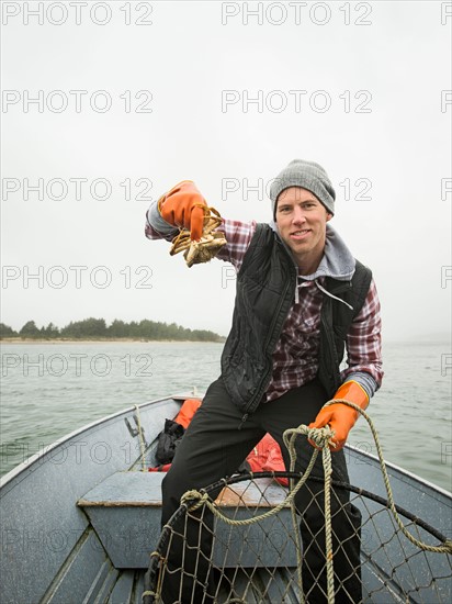 Portrait of man showing crab