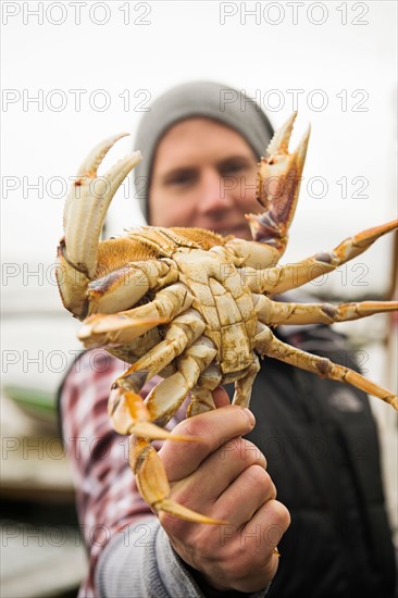 Portrait of man showing crab