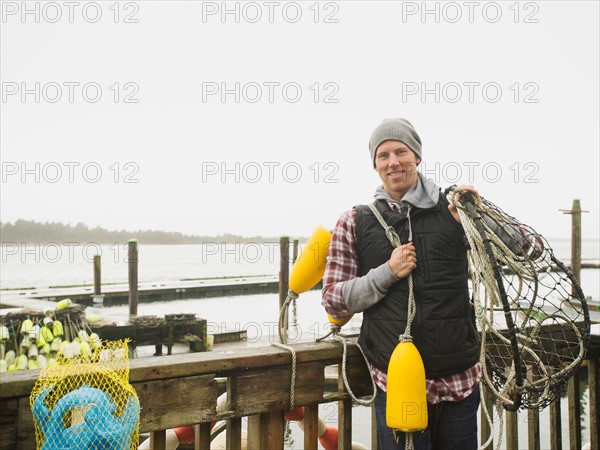 Portrait of man holding fishing equipment