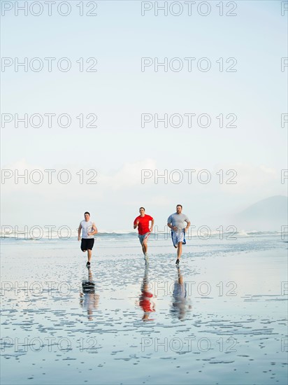 Men running on beach