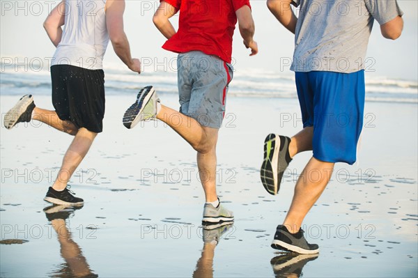 Men running on beach