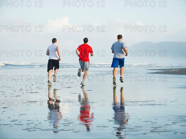 Men running on beach