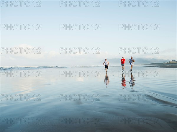 Men running on beach