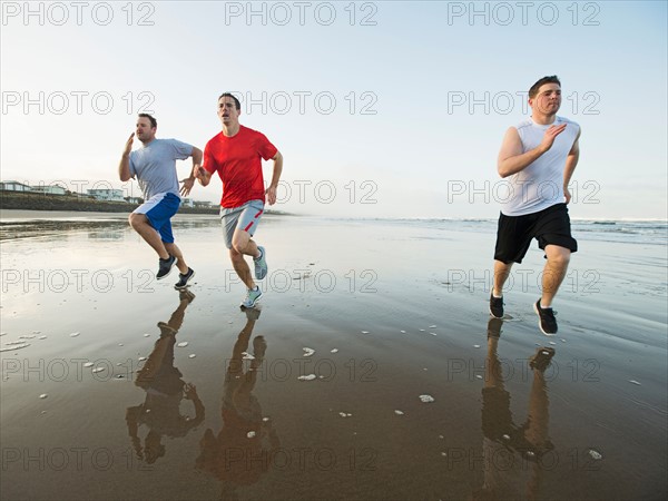 Men running on beach