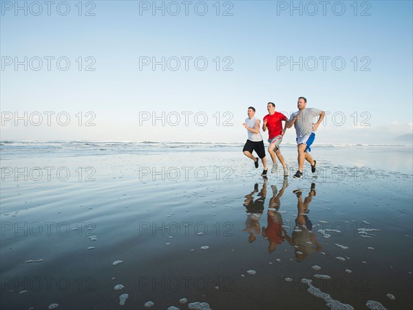 Men running on beach