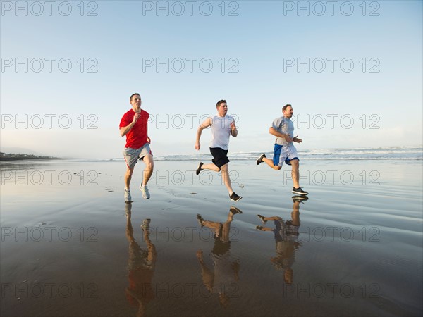 Men running on beach