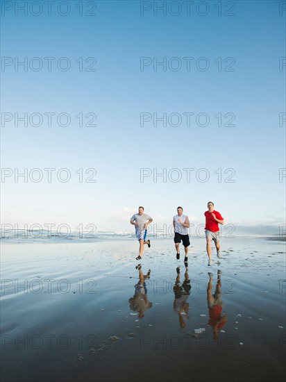 Men running on beach