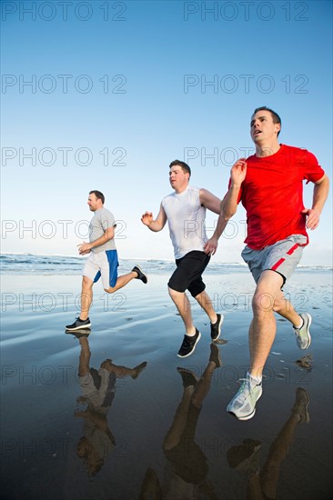 Men running on beach