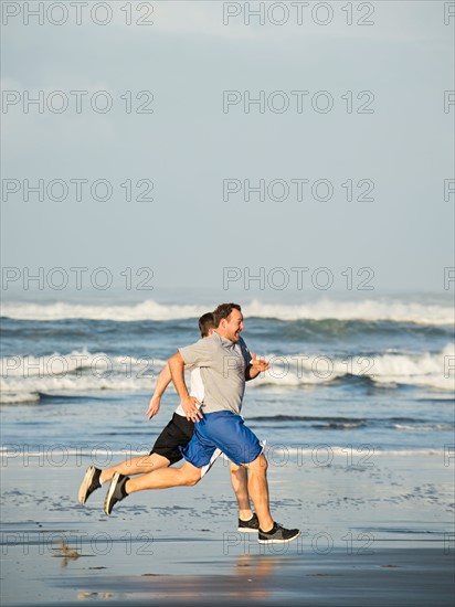 Men running on beach