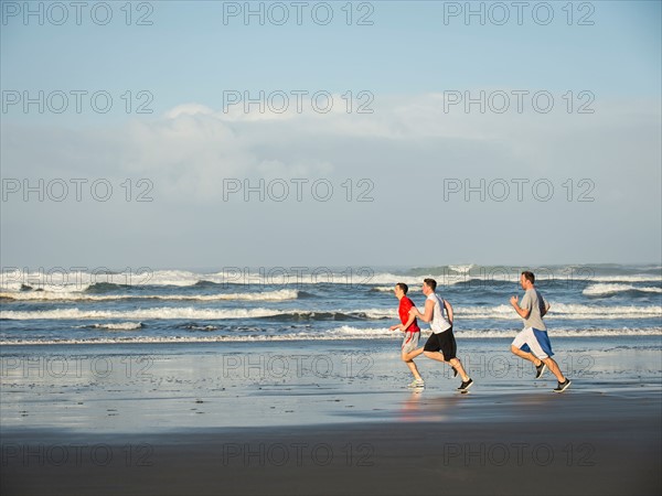 Men running on beach