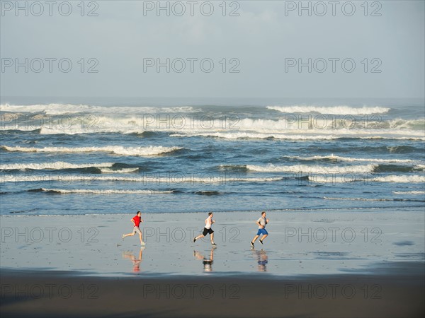 Men running on beach