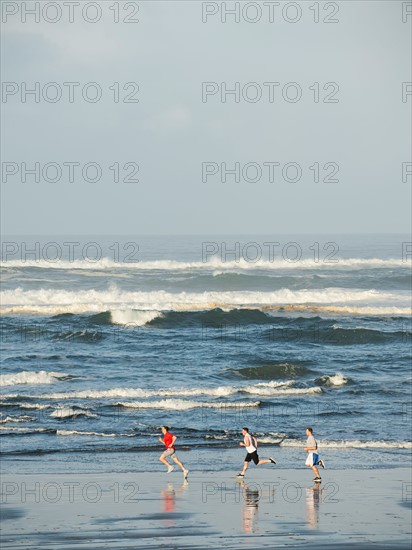 Men running on beach