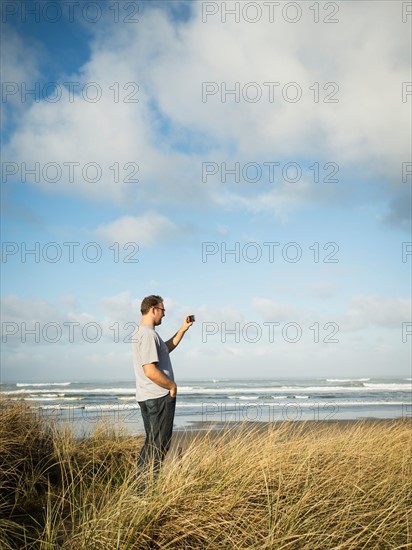 Mid adult man taking photograph