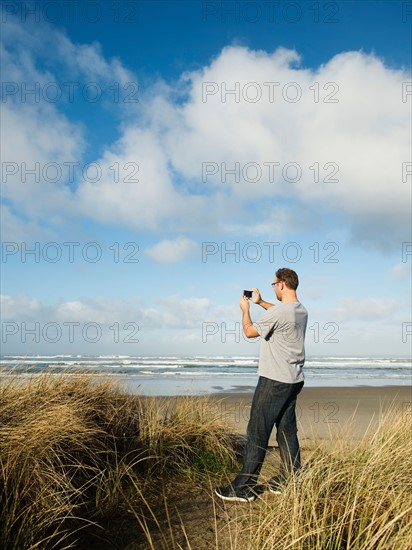 Mid adult man taking photograph