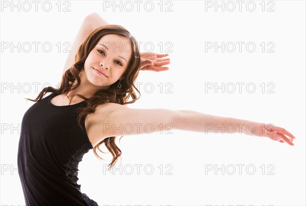 Portrait of girl (12-13) with arms outstretched