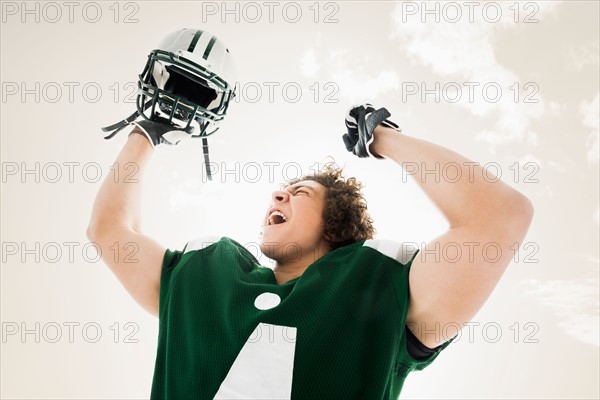 Portrait of American football player celebrating victory