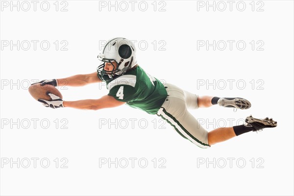 Portrait of American football player catching ball