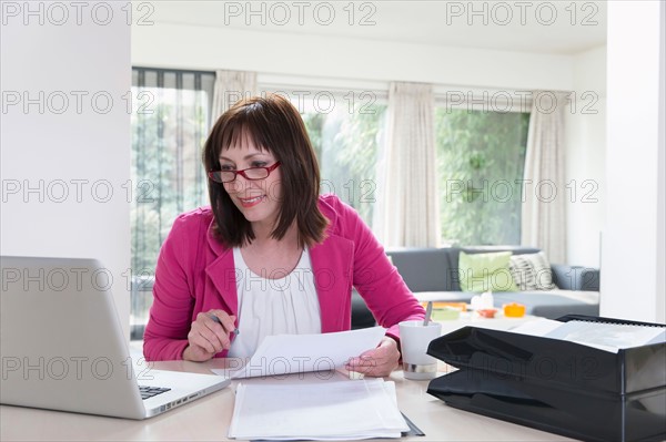 Mature businesswoman doing paperwork