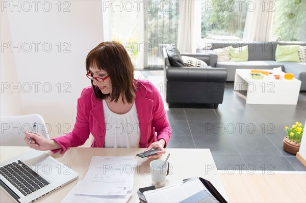 Mature businesswoman doing paperwork