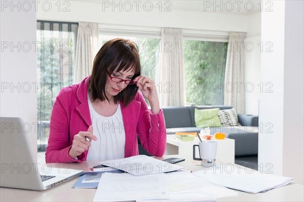 Mature businesswoman doing paperwork