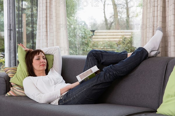 Mature woman relaxing on sofa