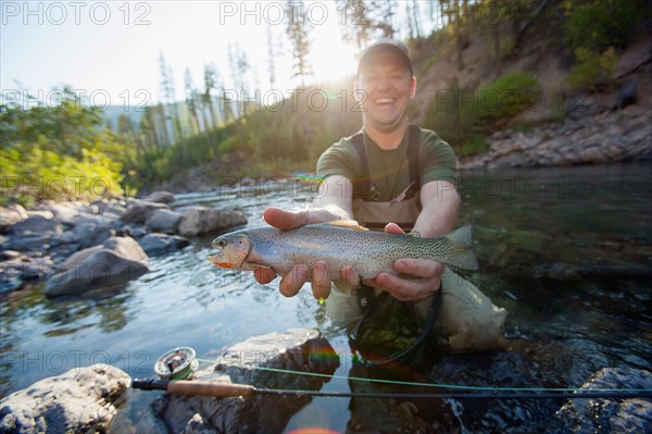 Fisherman showing fresh trout