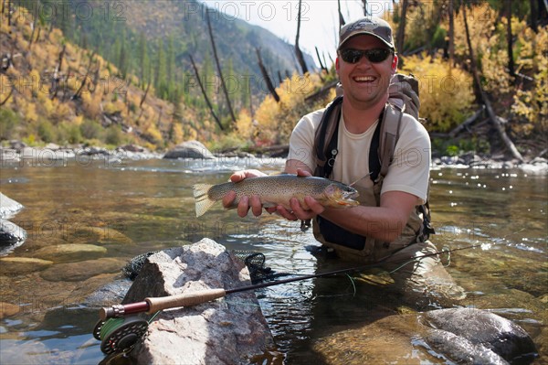 Fisherman showing fresh trout