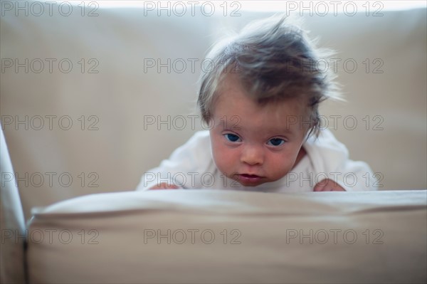 Portrait of baby girl (2-5 months) on sofa