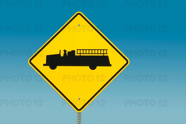 Yellow road sign depicting fire truck