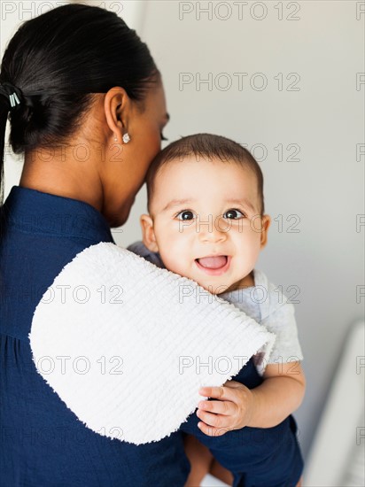 Mother holding baby boy (2-5 moths)