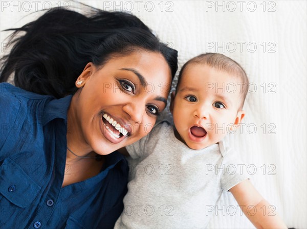 Portrait of happy mother with baby boy (2-5 months) making funny face