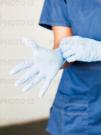Close-up of nurses hands-putting on surgical gloves
