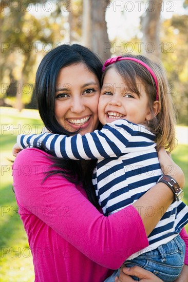 Portrait of smiling mother and daughter (4-5 years) hugging