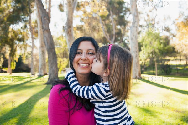 Portrait of smiling mother and daughter (4-5 years) kissing her