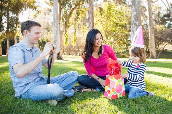 Family with daughter (4-5) playing in park