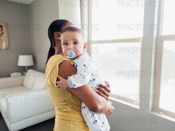 Woman holding her son (2-5 months)