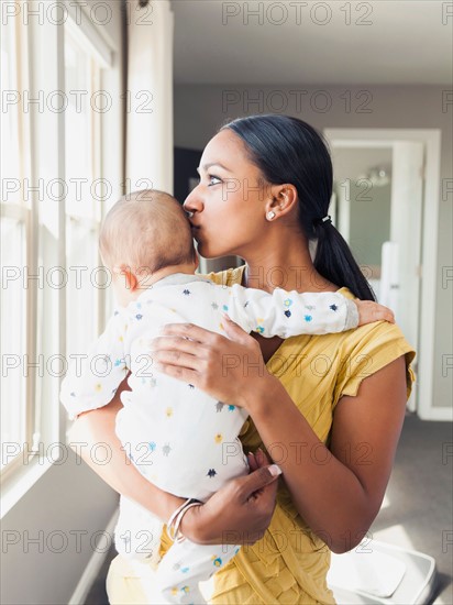 Woman holding her baby son (2-5 months)